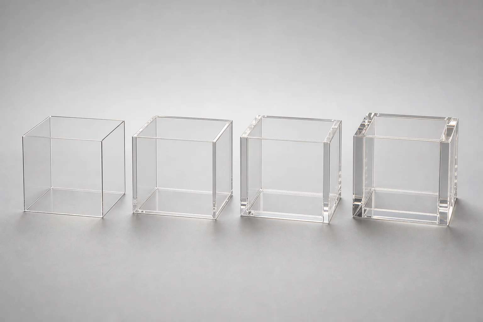 Four acrylic boxes of identical dimensions but different wall thicknesses displayed side-by-side