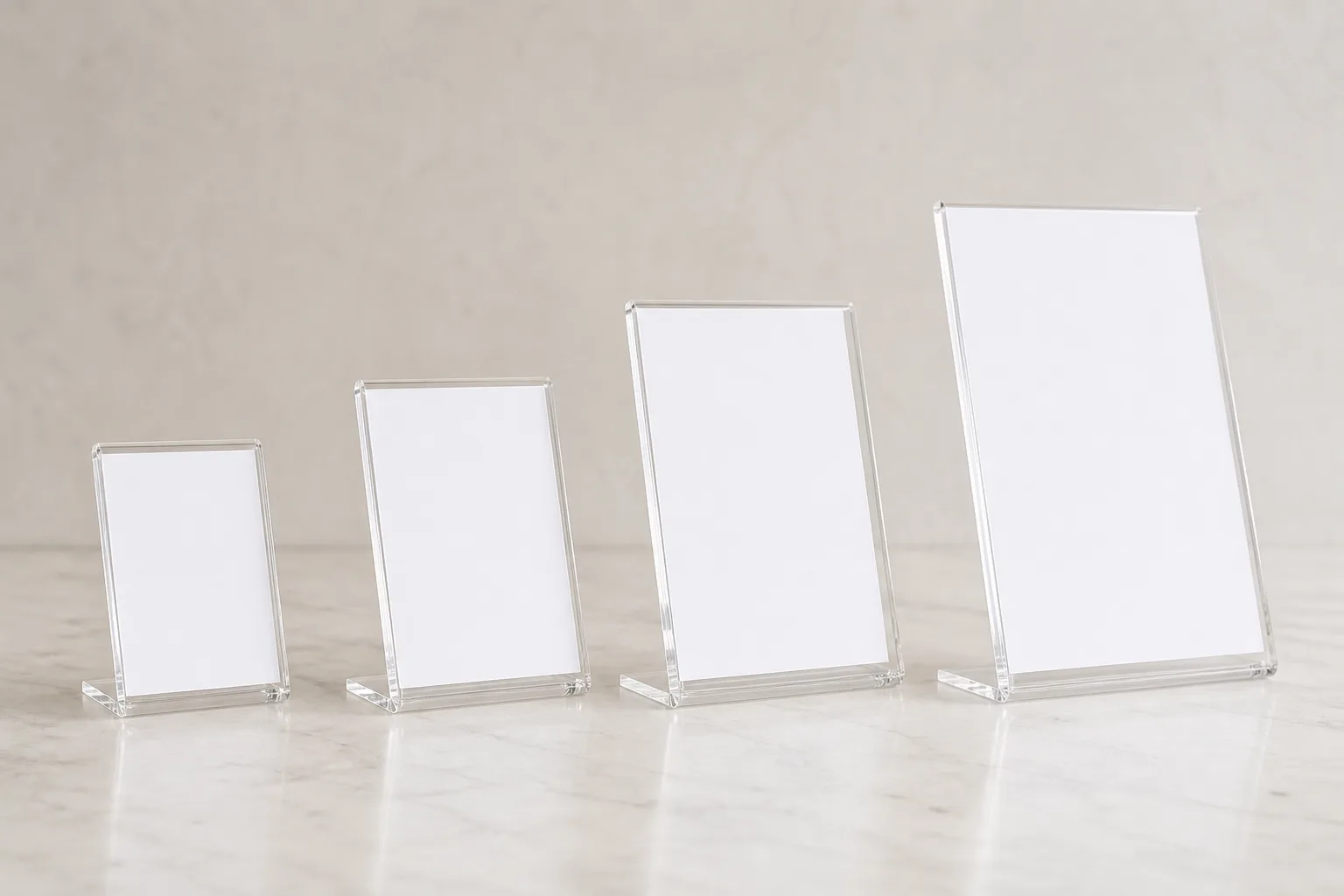 Row of clear acrylic sign holders in graduated sizes — 4x6, 5x7, 8.5 x 11, and 11x17 — lined up on a retail counter showing the size range on one chart