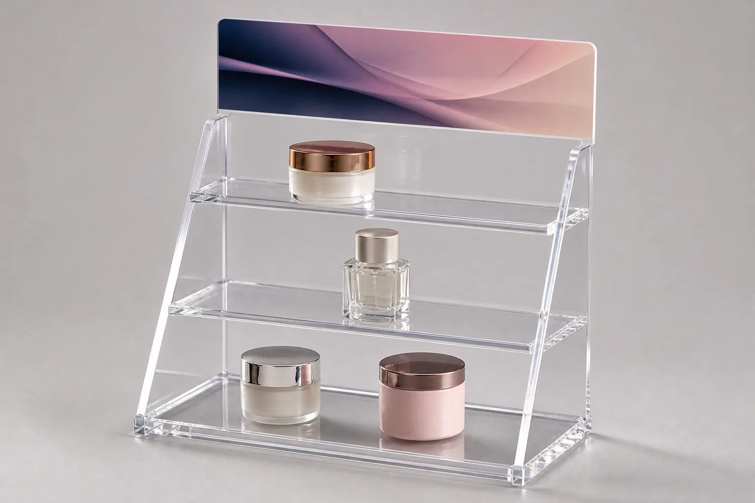 Clear cast acrylic countertop POP display with a UV-printed brand header holding retail product, its polished edges catching light against a soft studio backdrop