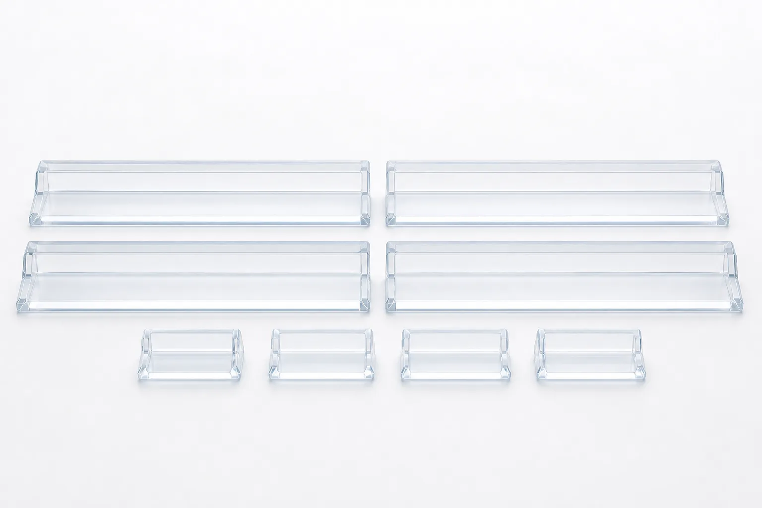 Four matching clear frosted acrylic mahjong tile racks arranged symmetrically with four pushers in front on white background