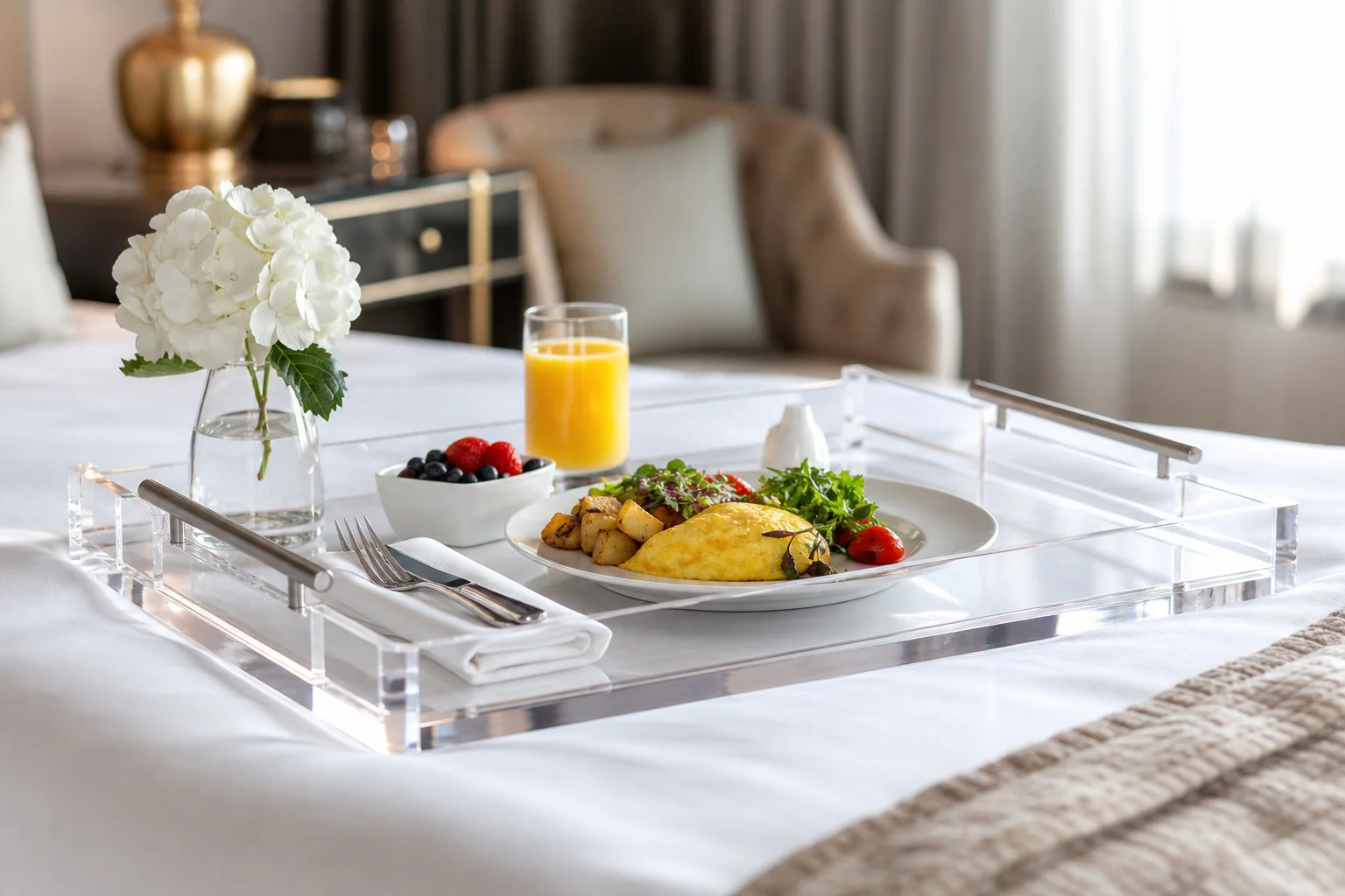 Clear acrylic serving tray with brushed metal handles on a hotel room service setup, translucent PMMA walls catching window light