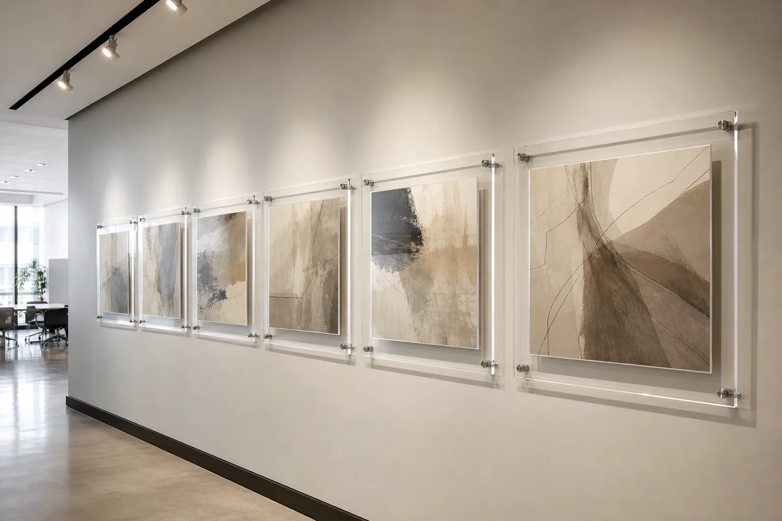 Gallery wall layout of frameless acrylic frames in a modern office corridor — a clean grid of standoff-mounted clear acrylic frames aligned on one centerline