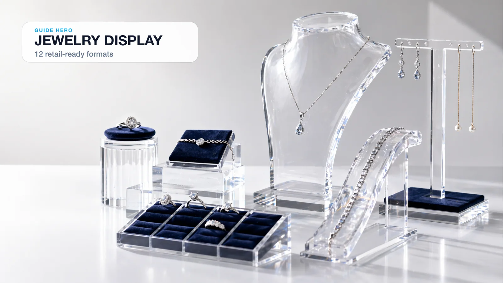 Custom acrylic jewelry display with tiered risers showing rings, necklaces, and earrings on velvet inserts under directed lighting