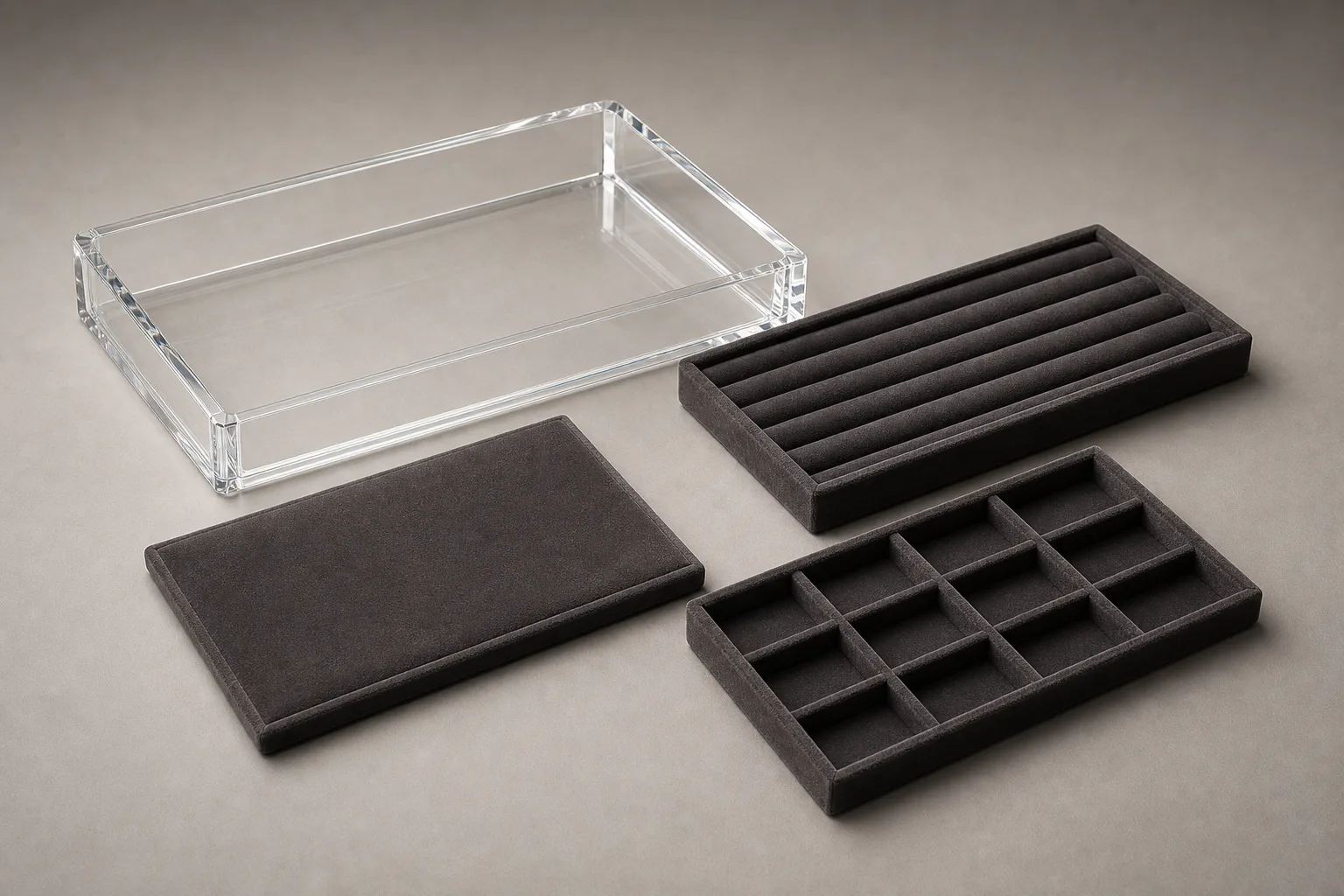 Acrylic jewelry display trays with interchangeable velvet inserts — ring rows, pendant pads, and an empty clear PMMA tray shell showing the swap system