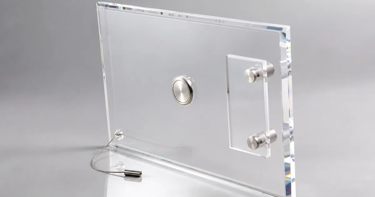 Clear cast acrylic wall display panel with embedded neodymium magnets on the back and a locking security base, shown alongside standoff and bracket mounting options for retail