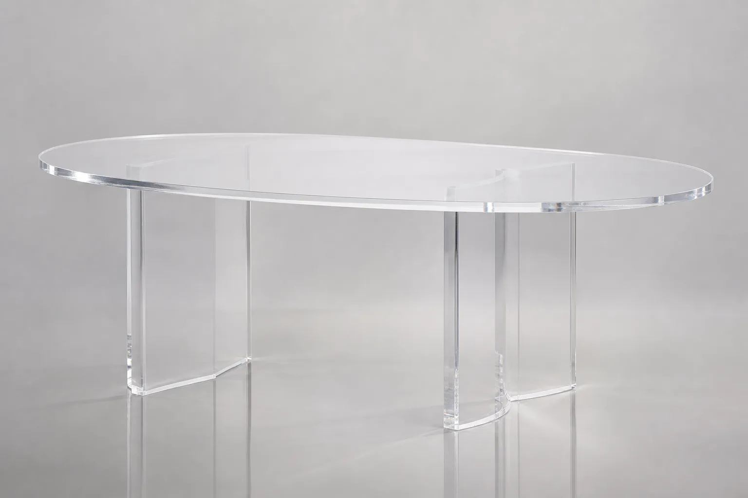 Oval clear cast acrylic dining table with diamond-polished boat-edge profile and trestle base, set for service in a boutique hotel restaurant private dining room