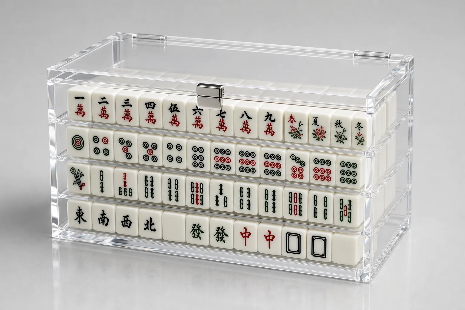 Clear hinged acrylic presentation case holding a mahjong tile set on a neutral studio background