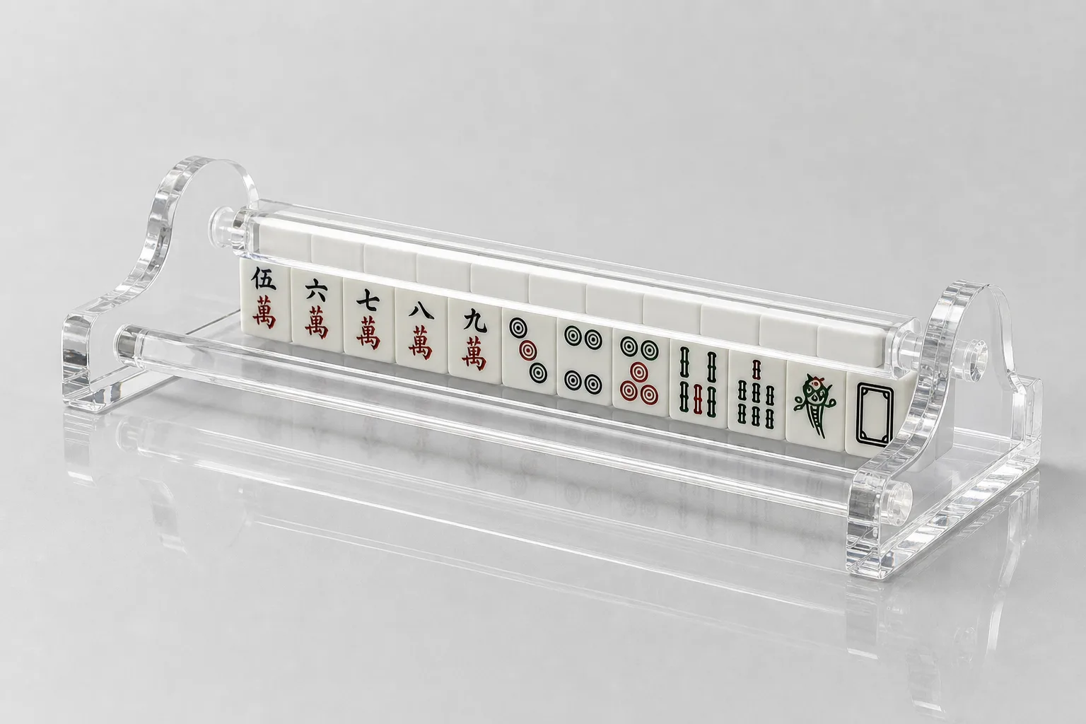 Editorial detail shot of a pastel mahjong rack-and-pusher set on a felted lounge surface — close-up of brass-pin pusher-to-rack integration with tile set partially visible above